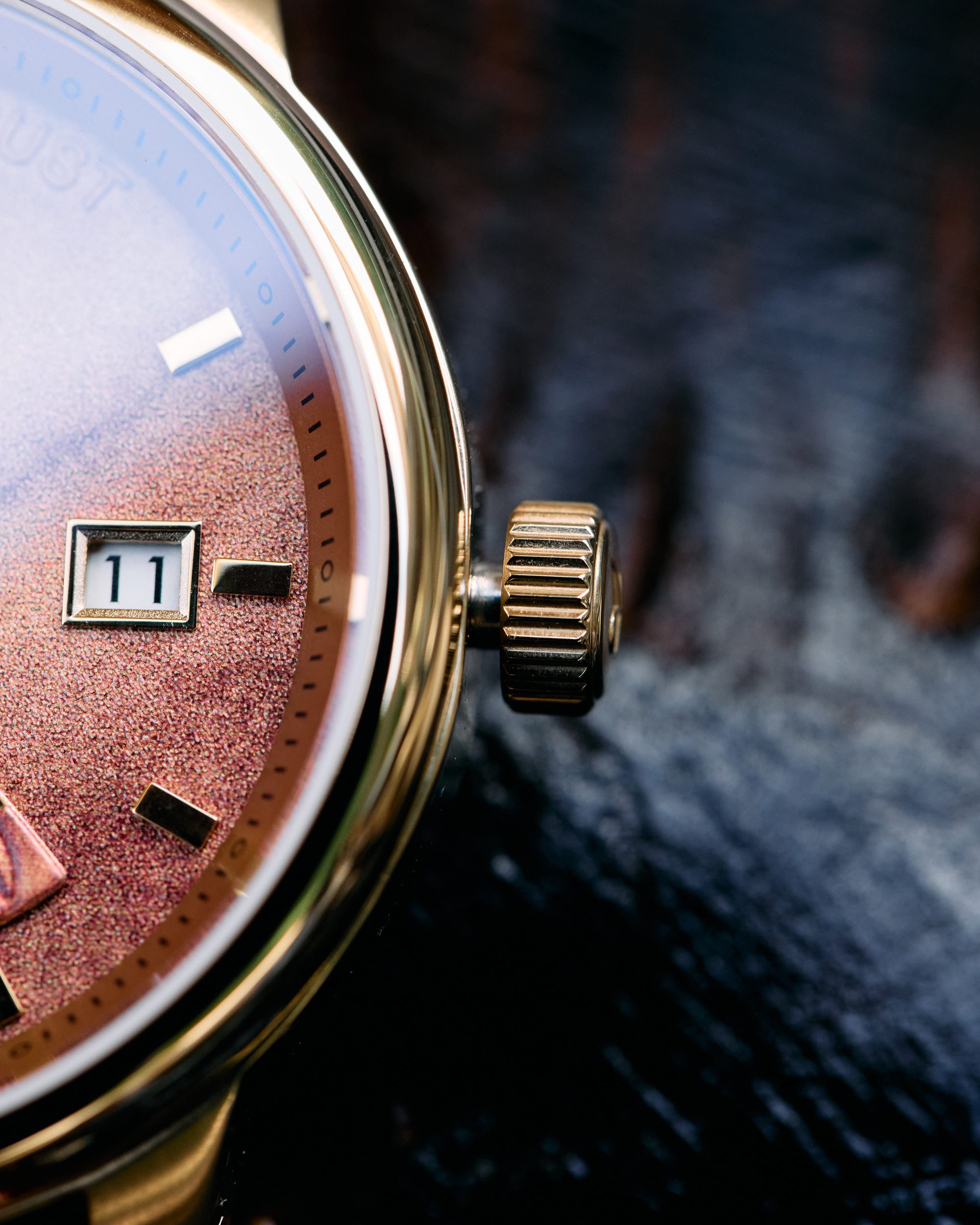 The Lincoln — gold fluted crown and framed date window in detail